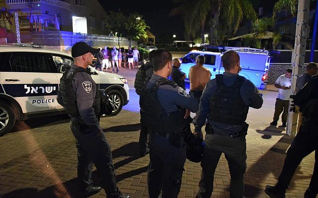 Israel Police officers search for pieces of rockets that were fired from the Gaza Strip and struck the southern Israeli town of Sderot on August 8, 2018. (Israel Police)