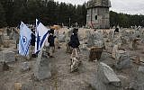 Israeli youths march by the monument to some 900,000 European Jews killed by the Nazis between 1941 and 1944 at the Treblinka death and labor camp, at Treblinka memorial, Poland on October 2, 2013. (AP Photo/Czarek Sokolowski)