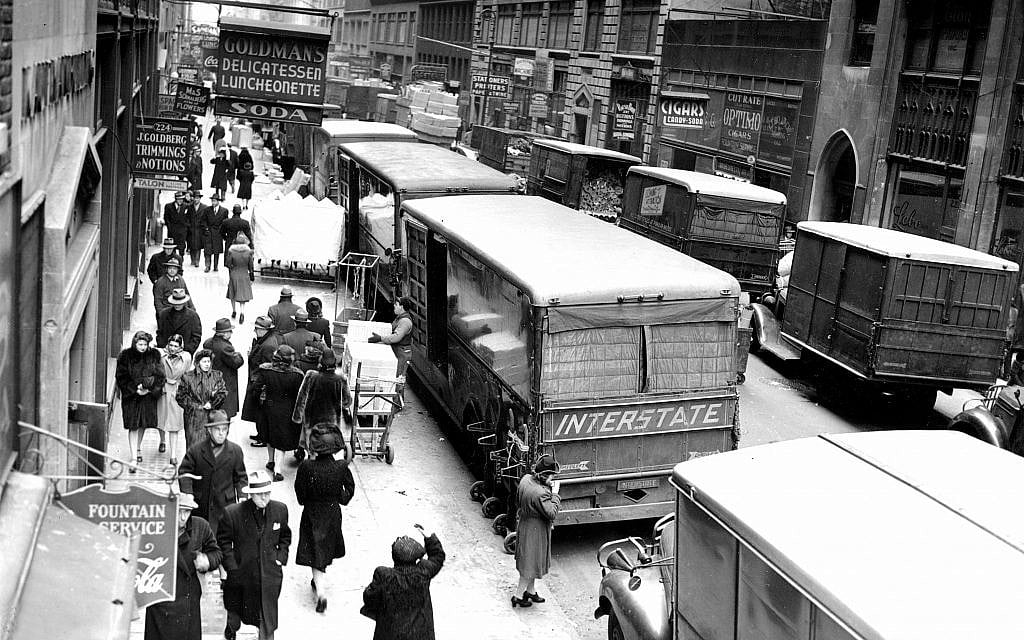 FILE - In this Nov. 29, 1943, file photo, people walk down on a street in New York's Garment District between Broadway and Eighth Avenue. Hundreds of thousands of garment workers once toiled in the sweaty, elbow-to-elbow workshops of midtown Manhattan before the whirring of sewing machines was mostly silenced by foreign competition. But a group of New Yorkers - manufacturers, landlords, designers, politicians - want to preserve some of the bustling sewing scene by zoning the neighborhood for at least 300,000 square feet of garment workshops now serving higher-end designers. (AP Photo/File)