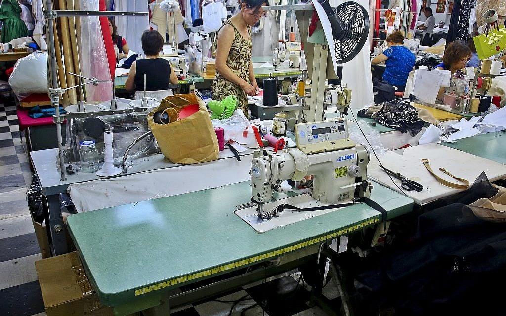 In this August 1, 2018 photo, a sewing station sits as garment workers assemble clothing at Absolute Couture, one of the few remaining garment manufacturers in New York's Garment District. (AP Photo/Bebeto Matthews)