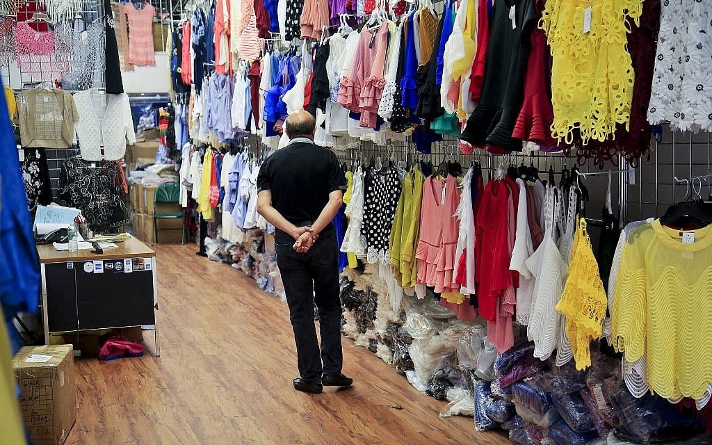 In this Aug. 1, 2018 photo, wall racks display samples of a variety of women's fashion offered at a wholesale store in New York's Garment District. A group of manufacturers, landlords, designers and politicians has a plan to preserve a remnant of the garment industry in a neighborhood where about 5,000 people are still employed in workshops mostly serving higher-end designers. (AP Photo/Bebeto Matthews)