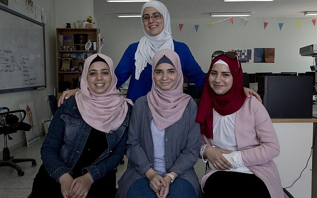 In this August 2, 2018 photo, Tamara Awaisa, 17, left, Wassan al-Sayed,17, center and Massa Halawa,16, right, pose for a photo with their mentor Yamama Shakaa in the West Bank city of Nablus. (AP Photo/Nasser Nasser) In this August 2, 2018 photo, Tamara Awaisa, 17, left, Wassan al-Sayed,17, center and Massa Halawa,16, right, pose for a photo with their mentor Yamama Shakaa in the West Bank city of Nablus. (AP Photo/Nasser Nasser)