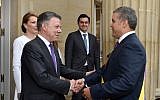 Colombia's outgoing president Juan Manuel Santos, center, welcoming newly sworn-in President Ivan Duque at the presidential palace, after his inauguration ceremony in Bogota, Colombia, August 7, 2018. (Colombia's presidential press office/ via AP)