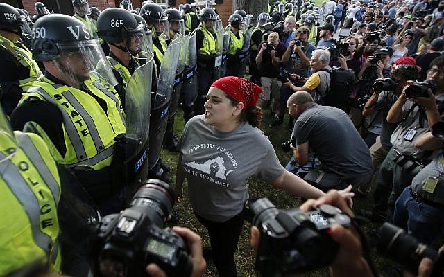 A protester confronts riot gear-clad police on the campus of the University of Virginia during a rally to mark the anniversary of last year's Unite the Right rally in Charlottesville, Virginia, Saturday, Aug. 11, 2018. (AP/Steve Helber) A protester confronts riot gear-clad police on the campus of the University of Virginia during a rally to mark the anniversary of last year's Unite the Right rally in Charlottesville, Virginia, Saturday, Aug. 11, 2018. (AP/Steve Helber)