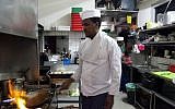Eritrean migrant Russom Weldu Weldeslasie works at a restaurant in Tel Aviv, Israel, August 8, 2018. (Caron Creighton/AP)