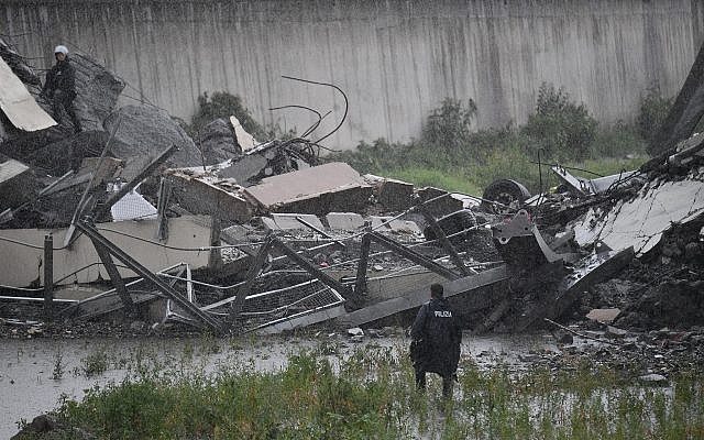 Rescues work among the debris of the collapsed Morandi highway bridge in Genoa, August 14, 2018. (Luca Zennaro/ANSA via AP) Rescues work among the debris of the collapsed Morandi highway bridge in Genoa, August 14, 2018. (Luca Zennaro/ANSA via AP)