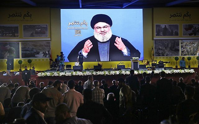 Hezbollah leader Hassan Nasrallah delivers a broadcast speech through a giant screen, during a rally marking the 12th anniversary of the 2006 Israel-Hezbollah war, in Beirut, Lebanon, on August 14, 2018. (AP Photo/Hussein Malla) Hezbollah leader Hassan Nasrallah delivers a broadcast speech through a giant screen, during a rally marking the 12th anniversary of the 2006 Israel-Hezbollah war, in Beirut, Lebanon, on August 14, 2018. (AP Photo/Hussein Malla)