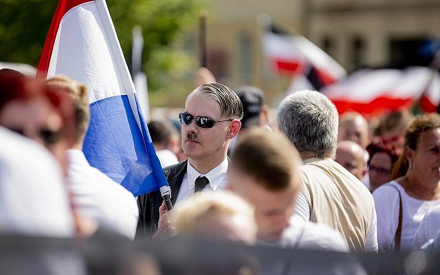 An Adolf Hitler lookalike attends a demonstration commemorating the 31st anniversary of the death of Hitler's deputy Rudolf Hess, in Berlin Saturday, Aug 18, 2018. Hess died 1987 in a prison in Berlin. (Christoph Soeder/dpa via AP) An Adolf Hitler lookalike attends a demonstration commemorating the 31st anniversary of the death of Hitler's deputy Rudolf Hess, in Berlin Saturday, Aug 18, 2018. Hess died 1987 in a prison in Berlin. (Christoph Soeder/dpa via AP)