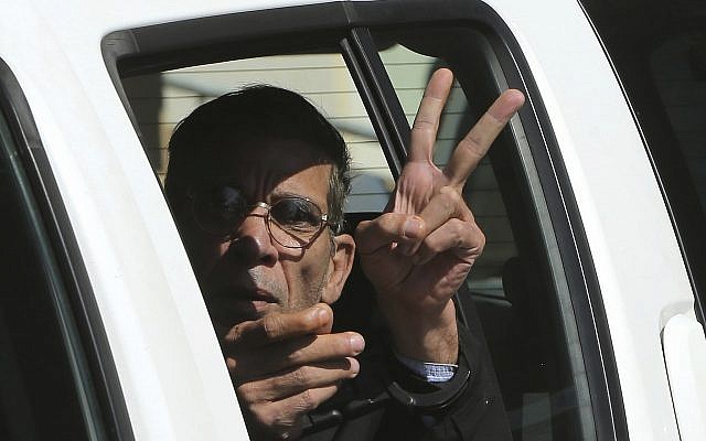 In this photo from March 30, 2016, Seif Eddin Mustafa flashes the victory sign from inside a police car after leaving court for a remand hearing in the Cypriot coastal town of Larnaca. (AP Photo/Petros Karadjias, File) In this photo from March 30, 2016, Seif Eddin Mustafa flashes the victory sign from inside a police car after leaving court for a remand hearing in the Cypriot coastal town of Larnaca. (AP Photo/Petros Karadjias, File)