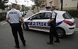 Illustrative: Police officers stand guard after a knife attack August 23, 2018 in Trappes, west of Paris. (AP Photo/Michel Euler)