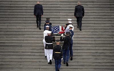 The flag-draped casket of Sen. John McCain, R-Ariz., is carried up the steps of the US Capitol, Friday, Aug. 31, 2018, in Washington. (Photo by John McDonnell/The Washington Post via AP, Pool)