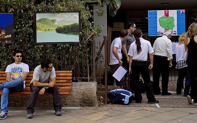 In this Thursday, Sept. 1, 2011, photo, people wait outside the Polish embassy in Tel Aviv, Israel. (AP Photo/Ariel Schalit) In this Thursday, Sept. 1, 2011, photo, people wait outside the Polish embassy in Tel Aviv, Israel. (AP Photo/Ariel Schalit)