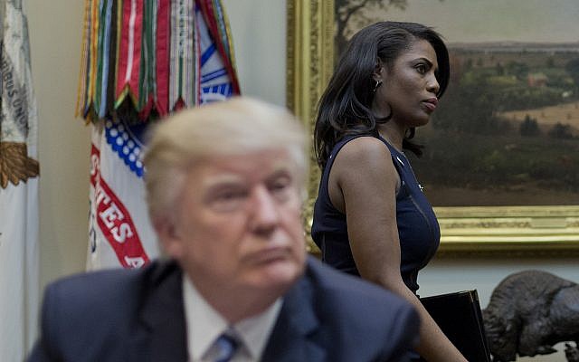 Then White House Director of communications for the Office of Public Liaison Omarosa Manigault, right, walks past President Donald Trump during a meeting on healthcare in the Roosevelt Room of the White House in Washington, March 13, 2017. (AP Photo/Pablo Martinez Monsivais) Then White House Director of communications for the Office of Public Liaison Omarosa Manigault, right, walks past President Donald Trump during a meeting on healthcare in the Roosevelt Room of the White House in Washington, March 13, 2017. (AP Photo/Pablo Martinez Monsivais)
