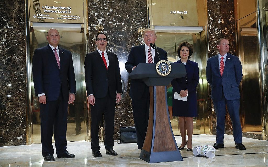 President Donald Trump speaks to the media in the lobby of Trump Tower, Tuesday, Aug. 15, 2017 in New York. With Trump are from l-r., National Economic Council Director Gary Cohn, Treasury Secretary Steven Mnuchin, Transportation Secretary Elaine Chao and OMB Director Mick Mulvaney. (AP Photo/Pablo Martinez Monsivais)