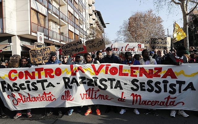 Demonstrators hold a banner reading 'Against Violence, Fascist, Racist, Sexist, Solidarity to the victims of Macerata' during an anti-racism demonstration following last Saturday’s attacks in the Italian city of Macerata when six Africans were wounded in a two-hour drive-by shooting spree by a right-wing extremist, in Milan, Italy, February 10, 2018. (AP Photo/Antonio Calanni) Demonstrators hold a banner reading 'Against Violence, Fascist, Racist, Sexist, Solidarity to the victims of Macerata' during an anti-racism demonstration following last Saturday’s attacks in the Italian city of Macerata when six Africans were wounded in a two-hour drive-by shooting spree by a right-wing extremist, in Milan, Italy, February 10, 2018. (AP Photo/Antonio Calanni)