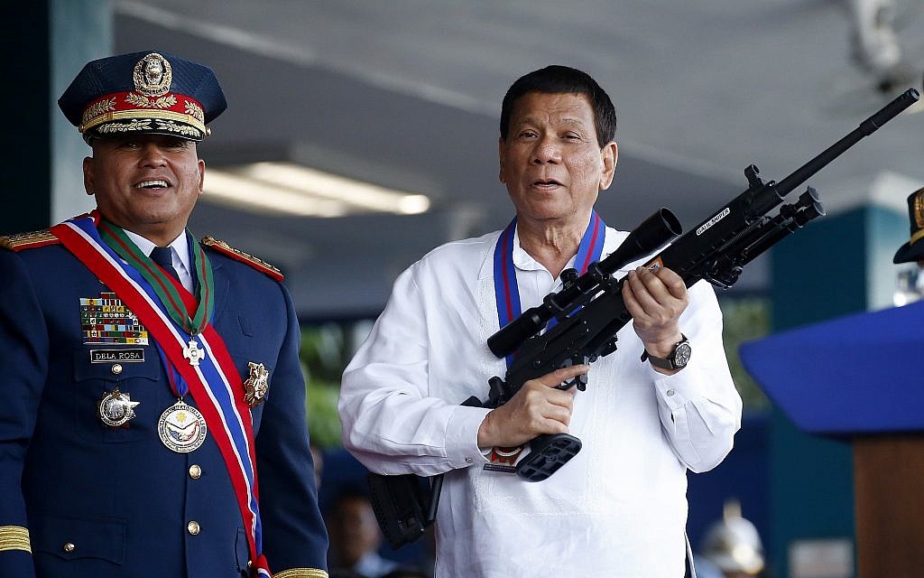 Philippine President Rodrigo Duterte jokes to photographers as he holds an Israeli-made Galil rifle which was presented to him by outgoing Philippine National Police Chief Director General Ronald "Bato" Dela Rosa, left, at the turnover-of-command ceremony on April 19, 2018, at Camp Crame in suburban Quezon city northeast of Manila, Philippines. (AP Photo/Bullit Marquez) Philippine President Rodrigo Duterte jokes to photographers as he holds an Israeli-made Galil rifle which was presented to him by outgoing Philippine National Police Chief Director General Ronald "Bato" Dela Rosa, left, at the turnover-of-command ceremony on April 19, 2018, at Camp Crame in suburban Quezon city northeast of Manila, Philippines. (AP Photo/Bullit Marquez)