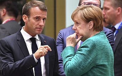 Illustrative: French President Emmanuel Macron, left, speaking with German Chancellor Angela Merkel during a round table meeting at an EU summit in Brussels, June 28, 2018. (AP Photo/Geert Vanden Wijngaert)