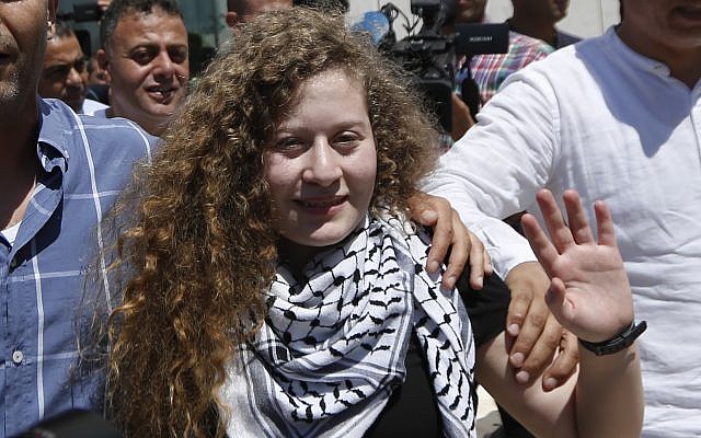 Ahed Tamimi waves after visiting the tomb of former Palestinian leader Yasser Arafat in the West Bank city of Ramallah, Sunday, July 29, 2018. (AP Photo/Majdi Mohammed)
