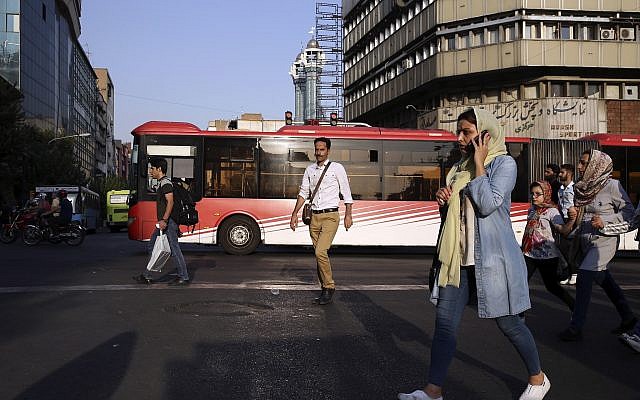 People cross Jomhouri-e-Eslami Street in downtown Tehran, Iran, Monday, July 30, 2018. (AP/Vahid Salemi) People cross Jomhouri-e-Eslami Street in downtown Tehran, Iran, Monday, July 30, 2018. (AP/Vahid Salemi)