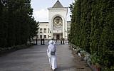 A woman walks toward the Russian Orthodox Church headquarters in the St. Daniel Monastery in Moscow, Russia, Aug. 3, 2018. (AP Photo/Pavel Golovkin)