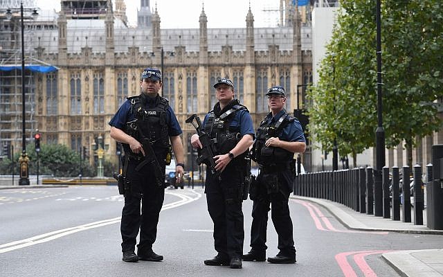 Illustrative: Armed police on Victoria Embankment in Westminster, after a car crashed into security barriers outside the Houses of Parliament, in London, August 14, 2018. (Stefan Rousseau/PA via AP)