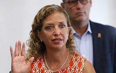 Rep. Debbie Wasserman Schultz, D-Fla., gestures as she speaks against the dangers of 3D-printed guns, along with Fred Guttenberg, rear, during a news conference at the Sunrise Police Department, August 16, 2018, in Sunrise, Florida. (AP Photo/Wilfredo Lee)