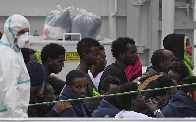 Migrants stand aboard the Italian Coast Guard ship Diciotti, moored at the Catania harbor, Aug. 21, 2018 (AP Photo/Salvatore Cavalli) Migrants stand aboard the Italian Coast Guard ship Diciotti, moored at the Catania harbor, Aug. 21, 2018 (AP Photo/Salvatore Cavalli)