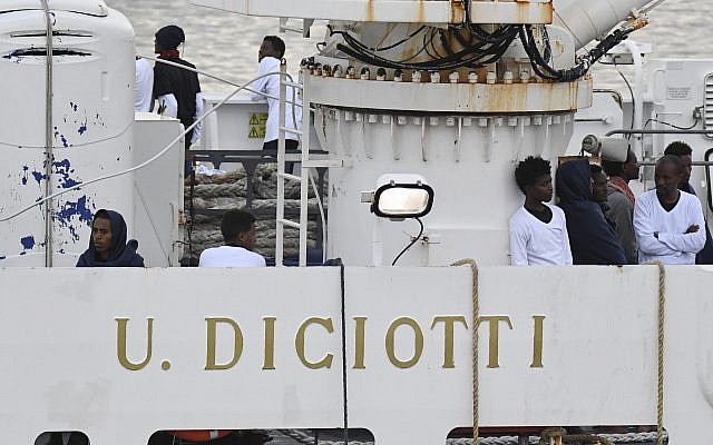 Migrants stand on the deck of the Italian Coast Guard ship Diciotti, moored at the Catania harbor, Aug. 21, 2018 (AP Photo/Salvatore Cavalli) Migrants stand on the deck of the Italian Coast Guard ship Diciotti, moored at the Catania harbor, Aug. 21, 2018 (AP Photo/Salvatore Cavalli)