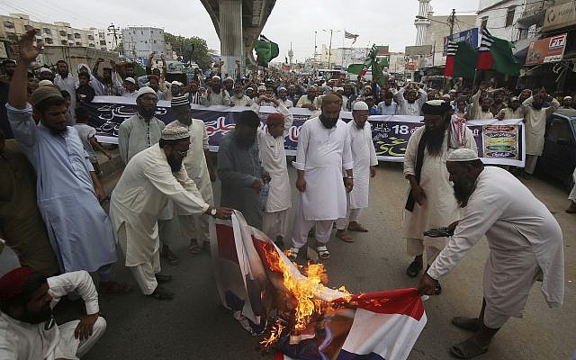 Pakistani protesters burn representation of Dutch flags during a protest to condemn the planned anti-Islam cartoon contest, in Karachi, Pakistan, on August 30, 2018. (AP/Fareed Khan) Pakistani protesters burn representation of Dutch flags during a protest to condemn the planned anti-Islam cartoon contest, in Karachi, Pakistan, on August 30, 2018. (AP/Fareed Khan)