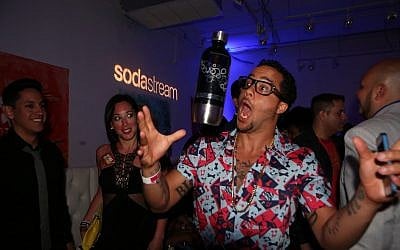 Sky Blu from LMFAO tossing a SodaStream bottle at the Universal Music Latin Entertainment Billboard after party on Thursday, April 25, 2013 in Miami, FL (Marianela Sanchez/Invision for SodaStream/AP Images)