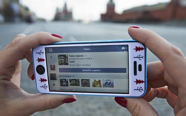 A user of Russia’s leading social network internet site VKontakte, poses holding an iPhone showing the account page of Pavel Durov, the former CEO and founder of VKontakte, in Red Square in Moscow, Russia, Wednesday, April 23, 2014 (AP Photo/Pavel Golovkin) A user of Russia’s leading social network internet site VKontakte, poses holding an iPhone showing the account page of Pavel Durov, the former CEO and founder of VKontakte, in Red Square in Moscow, Russia, Wednesday, April 23, 2014 (AP Photo/Pavel Golovkin)