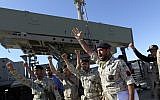 Illustrative: Iranian navy personnel celebrate after successfully launching a Ghader missile from the Jask port area on the shores of the Gulf of Oman during a drill near the Strait of Hormuz, Tuesday, January 1, 2013. (AP/Jamejam Online, Azin Haghighi)