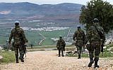 Spanish UN peacekeepers patrol in the disputed Shebaa Farms area between Lebanon and Israel, overlooking the divided border village of Ghajar, February 24, 2015. (AP /Hussein Malla)