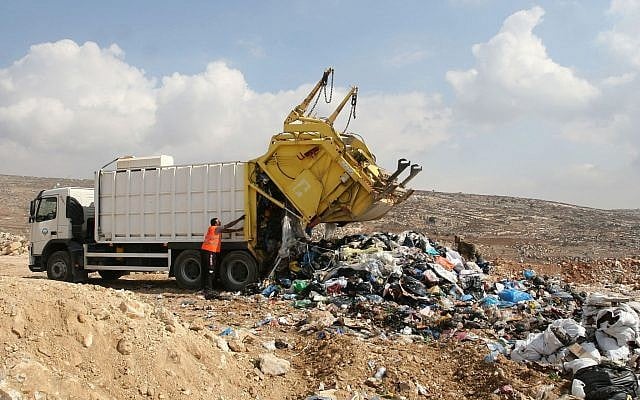 Illustrative: Palestinian workers try to remove scrap iron from an illegal garbage dump near the West Bank city of Ramallah. October 27, 2011. (Issam Rimawi/FLASH90) Illustrative: Palestinian workers try to remove scrap iron from an illegal garbage dump near the West Bank city of Ramallah. October 27, 2011. (Issam Rimawi/FLASH90)