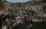 Hikers swim at the Zavitan spring on the Glan Heights in northern Israel, April 18, 2014. (Yaakov Naumi/Flash90)
