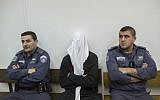 Ben Deri, center, a Border Police officer accused of shooting to death a Palestinian man during clashes in Betunia in the West Bank, seen during a hearing at the District Court in Jerusalem on December 30, 2014. (Yonatan Sindel/Flash90)