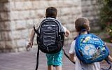 Illustrative: Israeli kids wearing school bags for first day of school outside their home in Jerusalem (Yonatan Sindel/Flash90)
