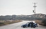 A Military Police car blocks a road leading to Zikim beach after it was closed to visitors, due to escalating rocket fire from the Gaza Strip toward southern Israel, on July 14, 2018. (Hadas Parush/Flash90)