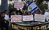 Protesters rail against against the annual Pride Parade in central Jerusalem, August 2, 2018. The signs read, "Jerusalem is the holy city," and "Jerusalem and Sodom are not twin cities." (Yonatan Sindel/Flash90)