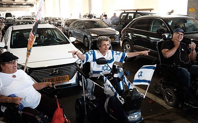 Disabled protesters block traffic at Ben Gurion Airport to call for higher monthly benefits on August 7, 2018. (Tomer Neuberg/Flash90) Disabled protesters block traffic at Ben Gurion Airport to call for higher monthly benefits on August 7, 2018. (Tomer Neuberg/Flash90)