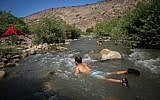 Young Israelis cool off in a stream in the Golan Heights, northern Israel. August 10, 2018. (David Cohen/Flash90)