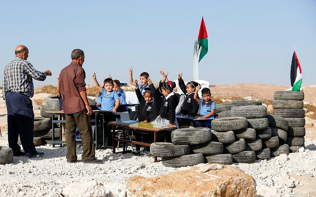 Palestinian school student study at their school that was demolished by Israeli authorities in the area of Khallet al-Daba south of Yatta in the city of Hebron on August 29, 2018. (Wisam Hashlamoun/Flash90)