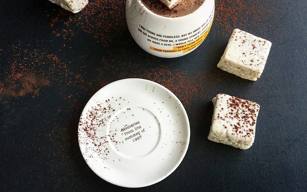 A mug of cocoa emblazoned with one of Oded Brenner's many short writings at his Blue Stripes shop in New York. (Courtesy)