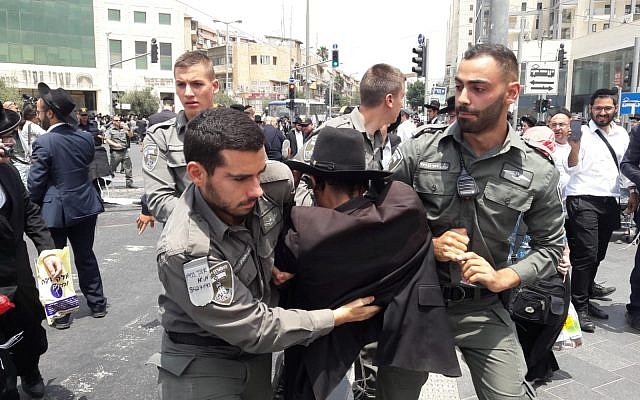Police arrest an ultra-Orthodox Jew protesting the arrest of a draft dodger on August 2, 2018, in Jerusalem (Israel Police) Police arrest an ultra-Orthodox Jew protesting the arrest of a draft dodger on August 2, 2018, in Jerusalem (Israel Police)