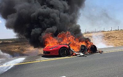 A burning Ferrari sports car is seen on Route 6 near the southern city of Kiryat Gat on August 10, 2018. (Israel Fire and Rescue Services Southern District)