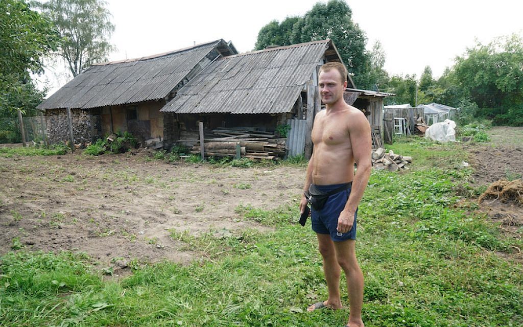 Sergey Levashov stands outside his grandmother’s home in Lyubavichi, August 26, 2018. (Cnaan Liphshiz)