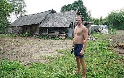 Sergey Levashov stands outside his grandmother’s home in Lyubavichi, August 26, 2018. (Cnaan Liphshiz)