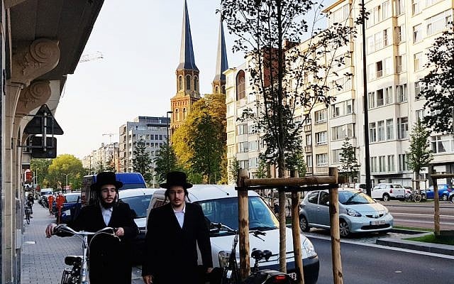 Two Jews walking down a street in Antwerp, Belgium, August 22, 2018. (Cnaan Liphshiz)