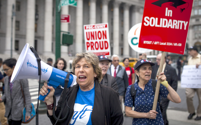 Randi Weingarten, with megaphone, marches in a New York City rally, June 27, 2018. (Courtesy Professional Staff Congress/via JTA)