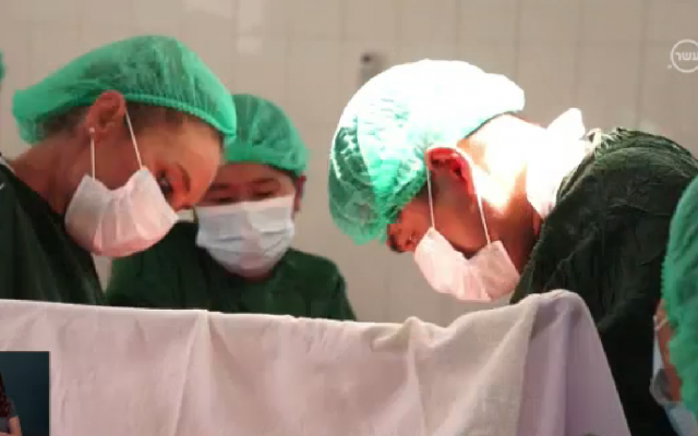 Dr. Ronit Almog, left, operating on a C-section delivery alongside local physicians at a hospital in Pindaya, in the Shan state of western Myanmar, August 2018. (Channel 10 screen capture) Dr. Ronit Almog, left, operating on a C-section delivery alongside local physicians at a hospital in Pindaya, in the Shan state of western Myanmar, August 2018. (Channel 10 screen capture)